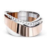 This unique band in two-tone 18k gold has a modern, organic design with rose and white gold overlapping, accented by a line of .16 ctw of white diamonds.