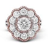 The dramatic floral cluster design of this white and rose gold vintage-inspired ring is set with 2.45 ctw round cut white diamonds and .21 ctw pink diamonds.