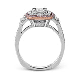This dramatic contemporary white and rose gold ring is highlighted by a sparkling halo set with .11 ctw pink diamonds and accented with .35 ctw round cut white diamonds, .38 ctw emerald cut diamonds, and .65 ctw baguette cut diamonds.