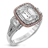 This dramatic contemporary white and rose gold ring is highlighted by a sparkling halo set with .11 ctw pink diamonds and accented with .35 ctw round cut white diamonds, .38 ctw emerald cut diamonds, and .65 ctw baguette cut diamonds.