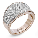 This bold statement ring is made from 18k rose and white gold and contains 2.01 ctw of white round brilliant diamonds as well as .23 ctw of pink diamonds.