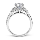 Featuring a delicately twisted shank, this brilliant white gold engagement ring and complimentary wedding band are set with .55 ctw of round cut white diamonds.