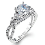 Featuring a delicately twisted shank, this brilliant white gold engagement ring and complimentary wedding band are set with .55 ctw of round cut white diamonds.