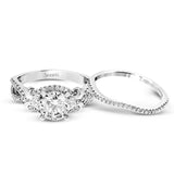 Featuring a delicately twisted shank, this brilliant white gold engagement ring and complimentary wedding band are set with .55 ctw of round cut white diamonds.