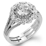 This lovely white gold contemporary ring features a dazzling halo of .10 ctw pink diamonds accented by 1.13 ctw round cut white diamonds.