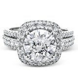 Featuring a brilliant halo setting, this contemporary white gold ring is set with 1.35 ctw glistening round cut white diamonds.