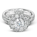 This lovely modern white gold ring features an eye-catching cluster halo set with .97 ctw shimmering round cut white diamonds.