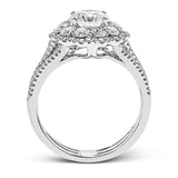 This lovely modern white gold ring features an eye-catching cluster halo set with .97 ctw shimmering round cut white diamonds.