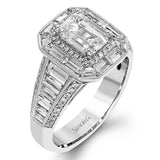 This lovely 18k white and rose gold ring has a graduated design which leads up to a rectangular center stone setting. The ring contains .18 ctw of round diamonds, .07 ctw of pink diamonds, and 1.48 ctw of baguette diamonds.