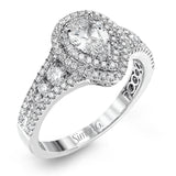 Featuring a pear-shaped double halo, this modern white gold engagement ring is highlighted by .68 ctw of round cut white diamonds.