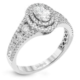 Featuring an exquisite contemporary design, this white gold engagement ring features an eye-catching oval double halo complemented by .68 ctw of round cut white diamonds.
