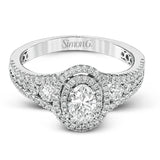Featuring an exquisite contemporary design, this white gold engagement ring features an eye-catching oval double halo complemented by .68 ctw of round cut white diamonds.