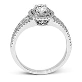 Featuring an exquisite contemporary design, this white gold engagement ring features an eye-catching oval double halo complemented by .68 ctw of round cut white diamonds.