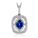This stunning white gold pendant features a .72 ctw oval shaped sapphire framed by .20 ctw of round white diamonds and a lovely filigree detail.