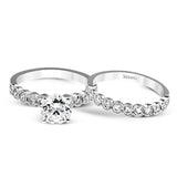 This engagement and wedding band set combines old and new with 1.09 ctw of round brilliant diamonds bezel set into 18k white gold, accented with vintage-inspired milgrain.