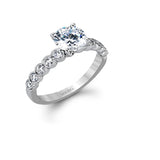 This engagement and wedding band set combines old and new with 1.09 ctw of round brilliant diamonds bezel set into 18k white gold, accented with vintage-inspired milgrain.