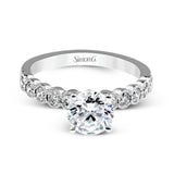 This engagement and wedding band set combines old and new with 1.09 ctw of round brilliant diamonds bezel set into 18k white gold, accented with vintage-inspired milgrain.