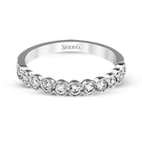 This engagement and wedding band set combines old and new with 1.09 ctw of round brilliant diamonds bezel set into 18k white gold, accented with vintage-inspired milgrain.