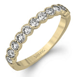 This engagement and wedding band set combines old and new with 1.09 ctw of round brilliant diamonds bezel set into 18k white gold, accented with vintage-inspired milgrain.