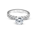 This engagement and wedding band set combines old and new with 1.09 ctw of round brilliant diamonds bezel set into 18k white gold, accented with vintage-inspired milgrain.