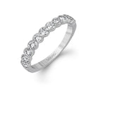 This engagement and wedding band set combines old and new with 1.09 ctw of round brilliant diamonds bezel set into 18k white gold, accented with vintage-inspired milgrain.