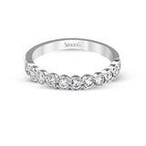 This engagement and wedding band set combines old and new with 1.09 ctw of round brilliant diamonds bezel set into 18k white gold, accented with vintage-inspired milgrain.