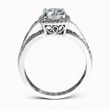 Featuring an impressive halo, this contemporary white gold engagement ring is accented by .22 ctw of round cut white diamonds and .42 ctw princess cut diamonds.