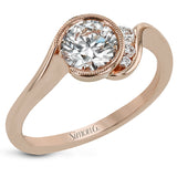 This distinctive, swirling ring design is set with .19 ctw and holds the center stone in a partial bezel setting.
