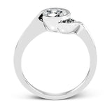 This distinctive, swirling ring design is set with .19 ctw and holds the center stone in a partial bezel setting.