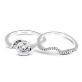 This distinctive, swirling ring design is set with .19 ctw and holds the center stone in a partial bezel setting.