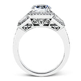 This design is a modern take on a classic design, with .29 ctw of round diamonds set into its halo and sides, and .31 ctw of baguette diamonds flanking the center stone.