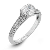 A modern take on a classic design, this white gold engagement ring is accented by .35 ctw of round cut white diamonds.