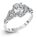 Accentuated with an impressive halo design, this contemporary white gold ring features .21 ctw round cut white diamonds.