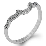 Accentuated with an impressive halo design, this contemporary white gold ring features .21 ctw round cut white diamonds.