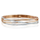 Featuring a distinctive contemporary design, this twist style bracelet is accentuated with 1.51 ctw of shimmering white diamonds in a dazzling white and rose gold setting.