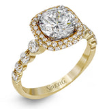 The delicate design of this classic white gold engagement ring features a sparkling pave halo accented with .86 ctw of shimmering round cut white diamonds.