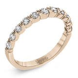 The delicate design of this classic white gold engagement ring features a sparkling pave halo accented with .86 ctw of shimmering round cut white diamonds.