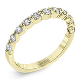 The delicate design of this classic white gold engagement ring features a sparkling pave halo accented with .86 ctw of shimmering round cut white diamonds.