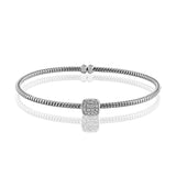Featuring an elegant open design, this contemporary white gold bangle bracelet is highlighted by .16 ctw glistening white diamonds accents. Perfect for stacking.