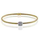 This contemporary yellow gold bangle bracelet features a lovely open design accented by .16 ctw shimmering round cut white diamonds. Perfect for stacking.