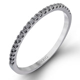 Presenting a lovely twisted shank design, this contemporary white gold engagement ring and wedding band set is accentuated with .44 ctw round cut white diamonds.