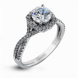 Presenting a lovely twisted shank design, this contemporary white gold engagement ring and wedding band set is accentuated with .44 ctw round cut white diamonds.