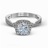 Presenting a lovely twisted shank design, this contemporary white gold engagement ring and wedding band set is accentuated with .44 ctw round cut white diamonds.