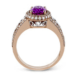 18KWR right hand ring with an intricate design along the shank has a diam halo .55 ctw, and an oval KNZT 5.89 ctw.