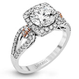 The delicate romantic design of this vintage inspired white and rose gold engagement ring and wedding band set is accentuated by .45 ctw of white diamonds and .08 ctw of pink diamonds.
