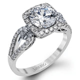 The delicate romantic design of this vintage inspired white and rose gold engagement ring and wedding band set is accentuated by .45 ctw of white diamonds and .08 ctw of pink diamonds.
