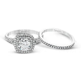 This eye-catching contemporary white gold engagement ring and wedding band set features an impressive halo accented by .63 ctw round cut white diamonds.