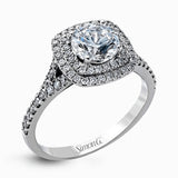 This eye-catching contemporary white gold engagement ring and wedding band set features an impressive halo accented by .63 ctw round cut white diamonds.