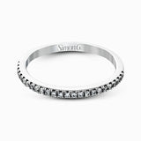 This eye-catching contemporary white gold engagement ring and wedding band set features an impressive halo accented by .63 ctw round cut white diamonds.