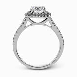 This eye-catching contemporary white gold engagement ring and wedding band set features an impressive halo accented by .63 ctw round cut white diamonds.